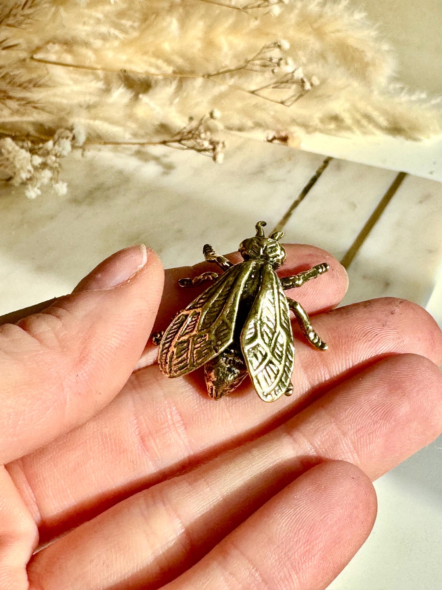 Solid brass bee figurine, realistic fly sculpture, metal insect ornament, detailed brass flying bug paperweight.
