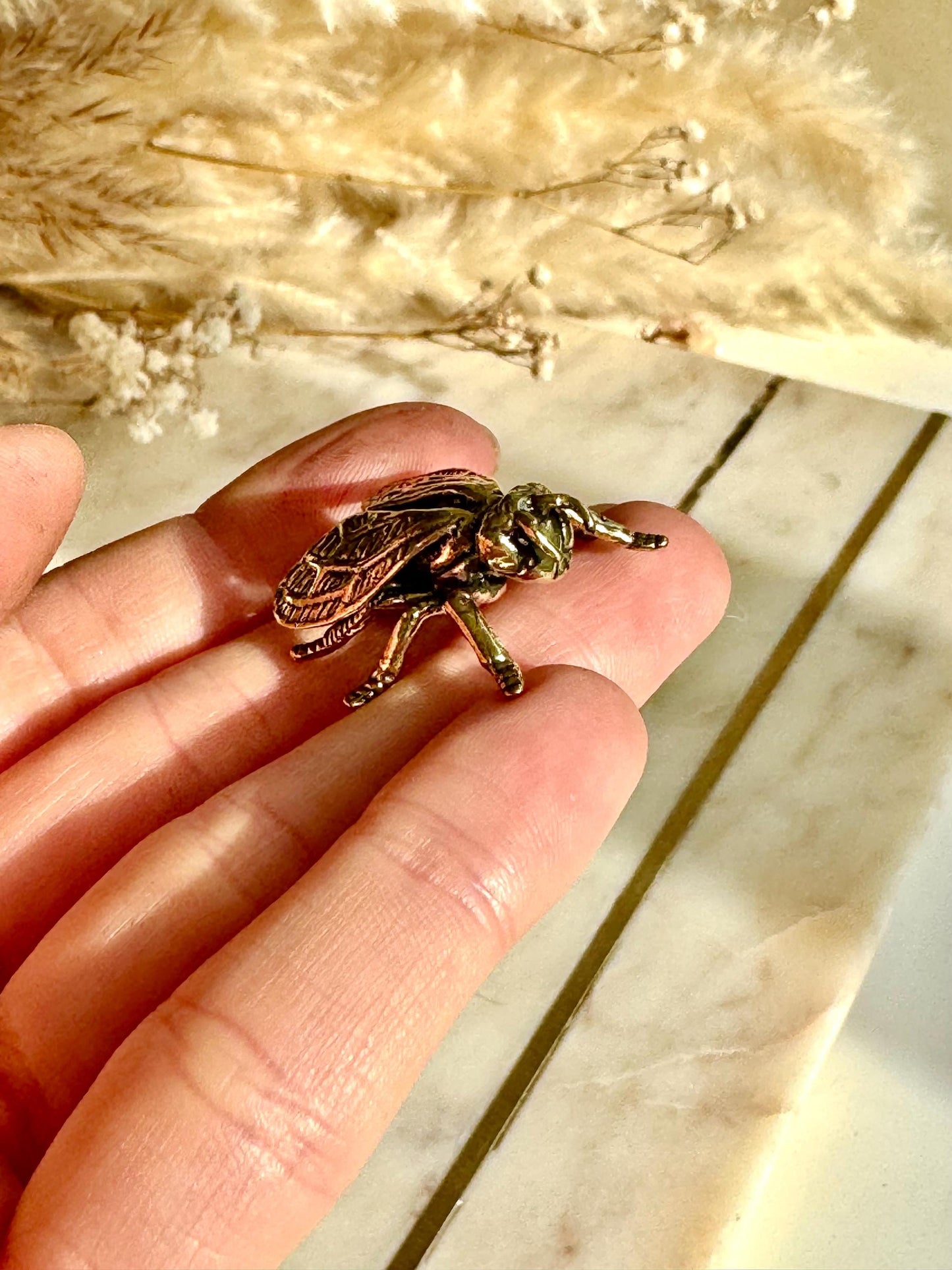 Solid brass bee figurine, realistic fly sculpture, metal insect ornament, detailed brass flying bug paperweight.