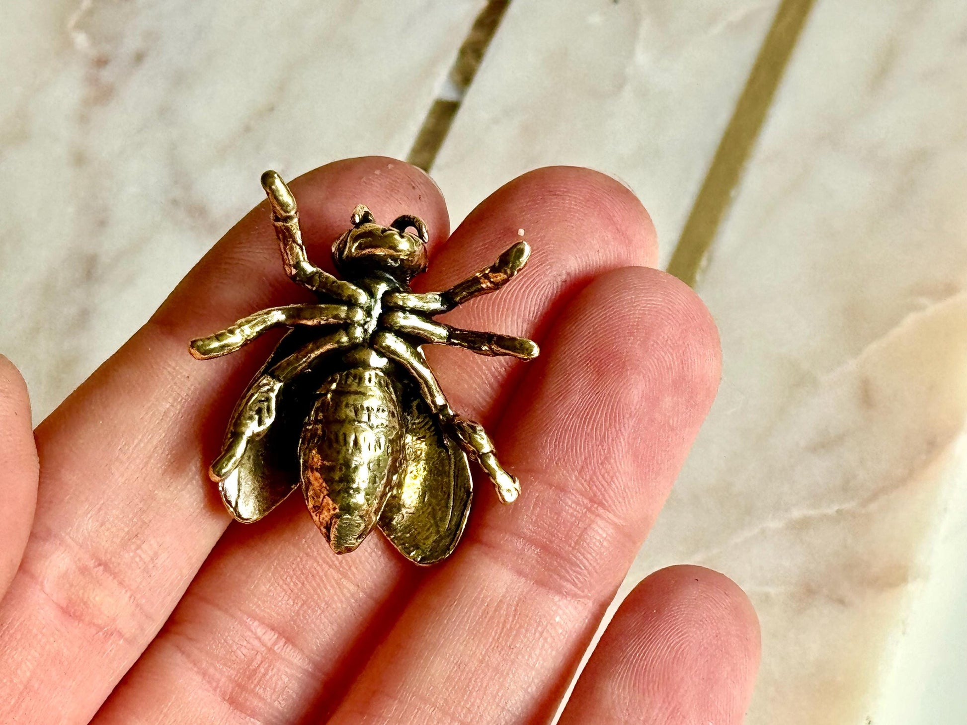 Solid brass bee figurine, realistic fly sculpture, metal insect ornament, detailed brass flying bug paperweight.
