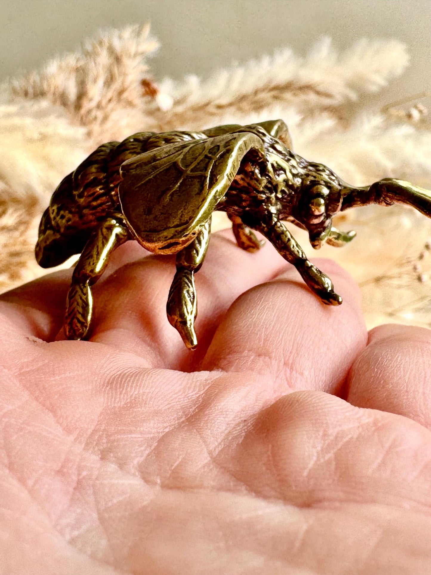 Solid brass bumblebee figurine, realistic bee sculpture, insect ornament, detailed brass garden pollinator paperweight.