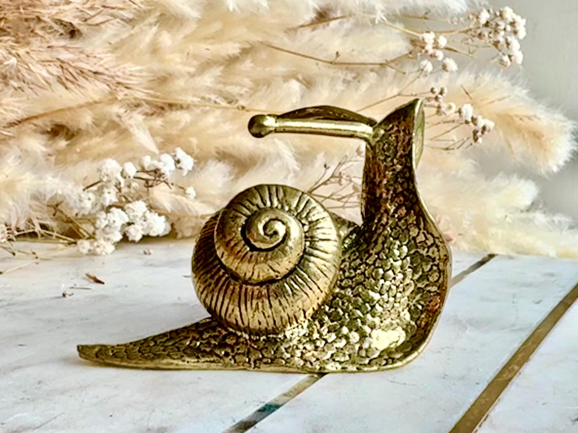 Lifelike solid brass snail figurine, detailed garden mollusk sculpture, vintage nature-inspired ornament, unique brass gastropod paperweight
