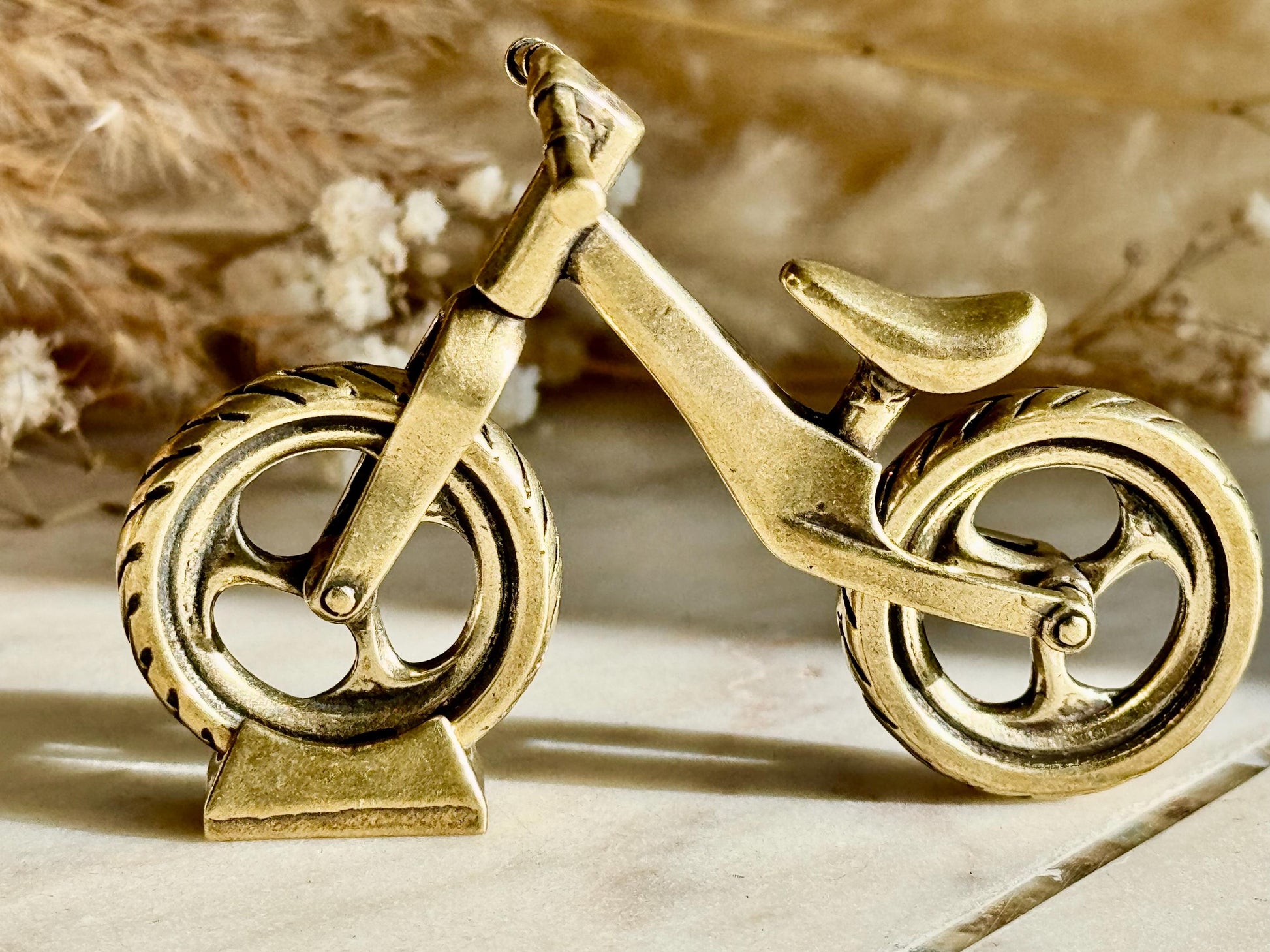 Solid brass balance bike figurine, rolling wheels model, miniature bicycle sculpture, unique metal cycling decor, collectible biker