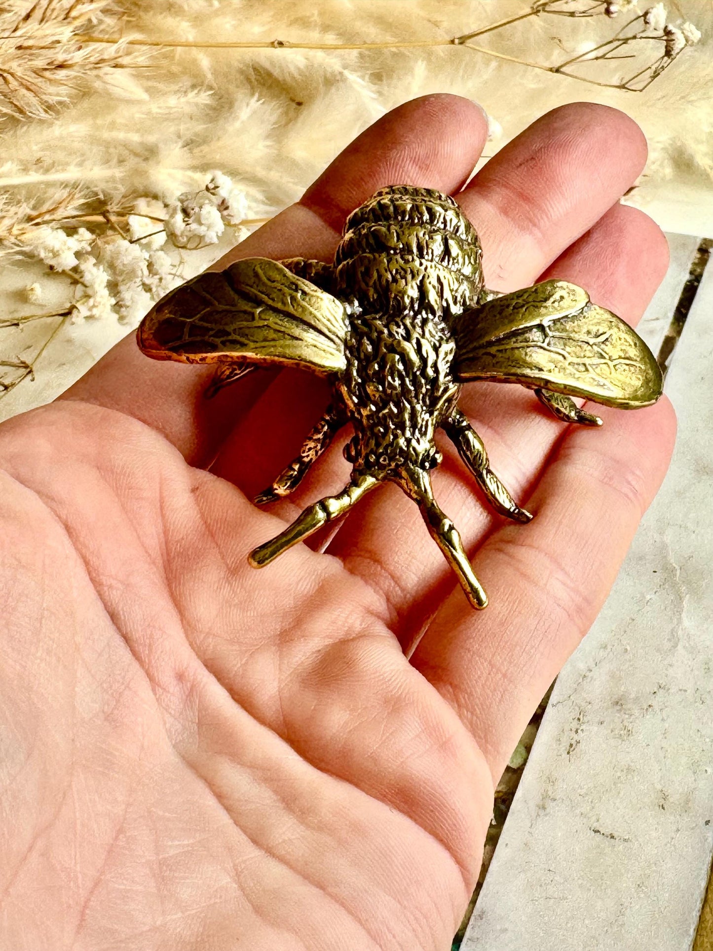 Solid brass bumblebee figurine, realistic bee sculpture, insect ornament, detailed brass garden pollinator paperweight.