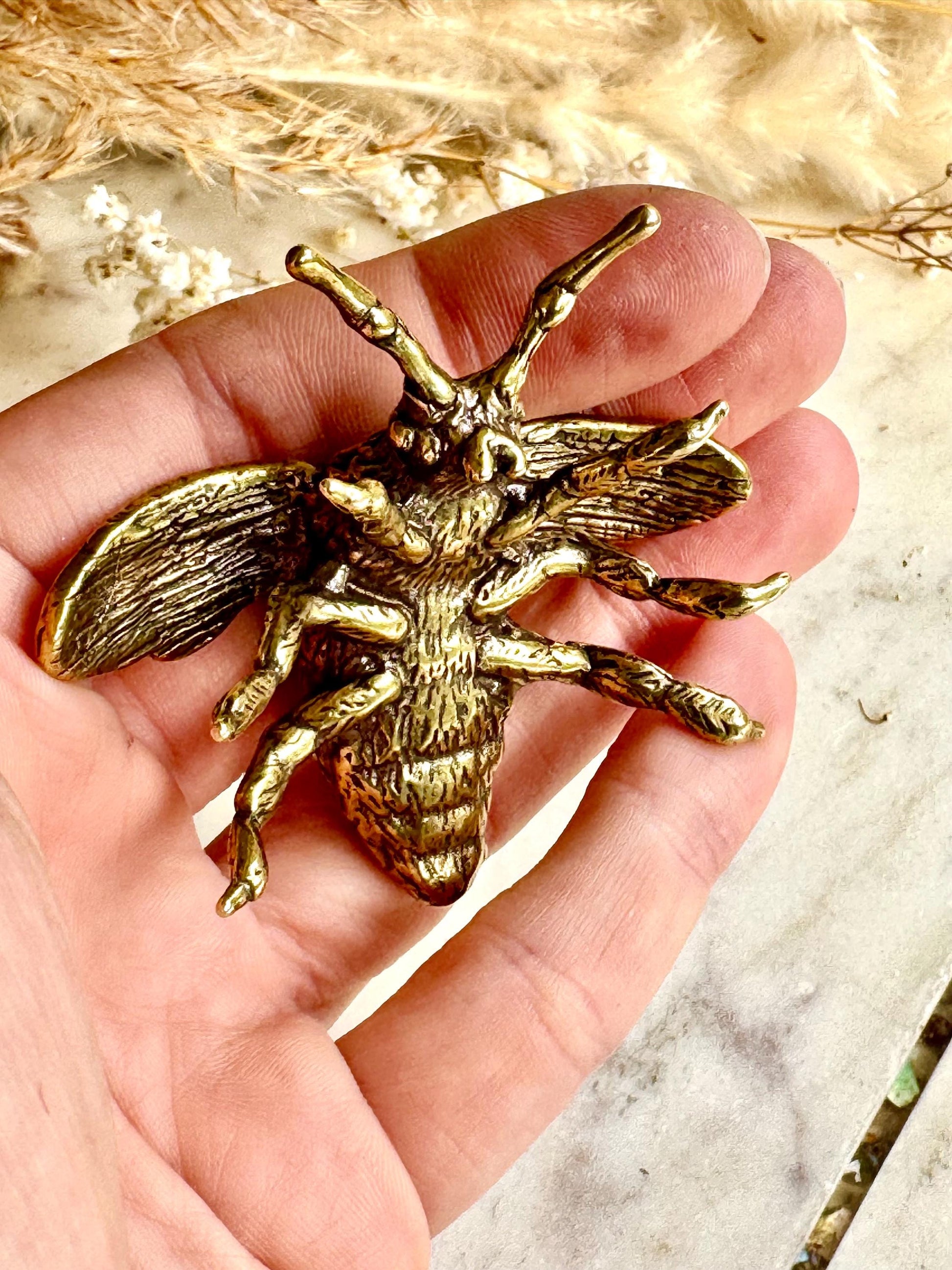 Solid brass bumblebee figurine, realistic bee sculpture, insect ornament, detailed brass garden pollinator paperweight.