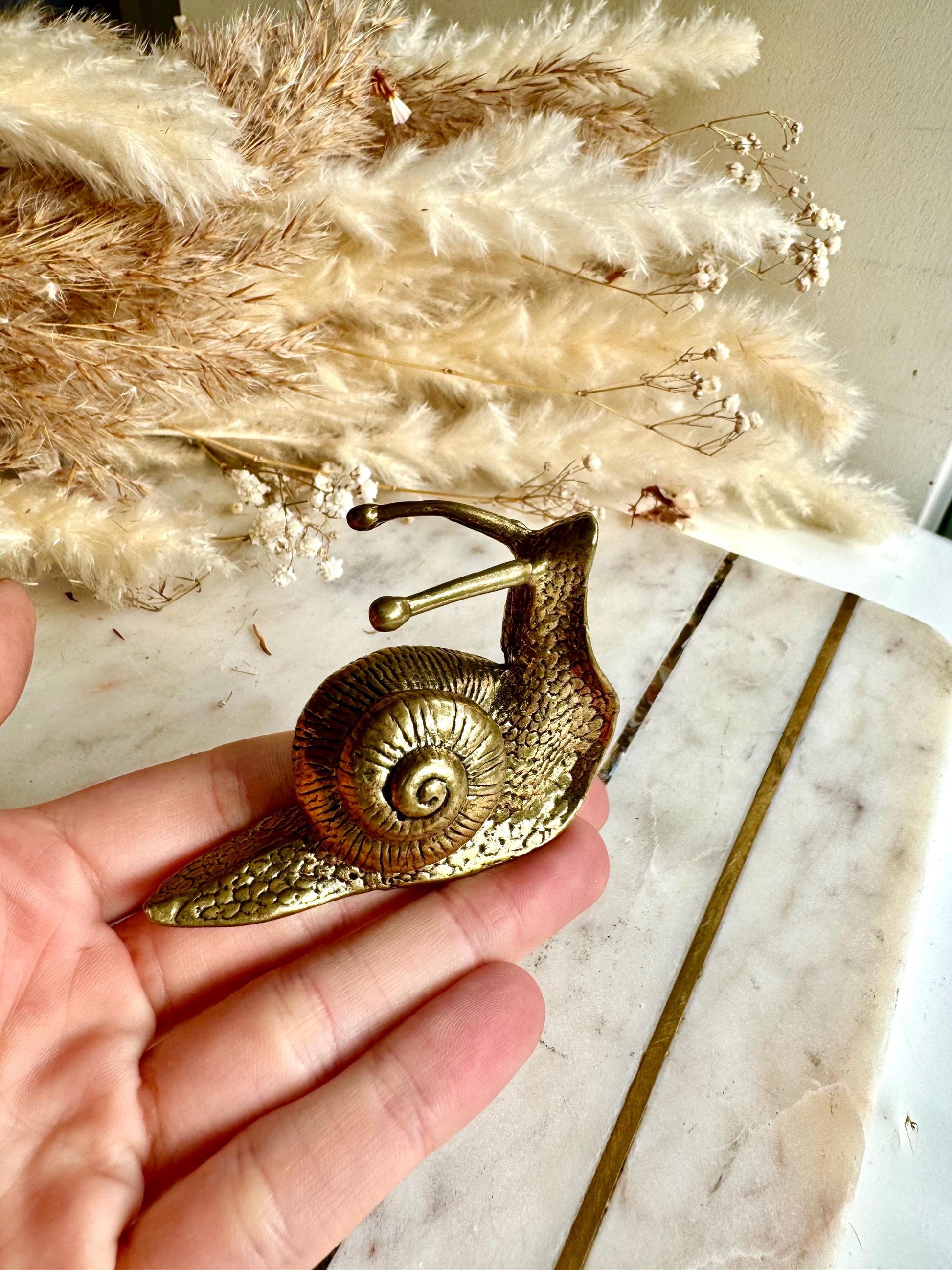 Lifelike solid brass snail figurine, detailed garden mollusk sculpture, vintage nature-inspired ornament, unique brass gastropod paperweight