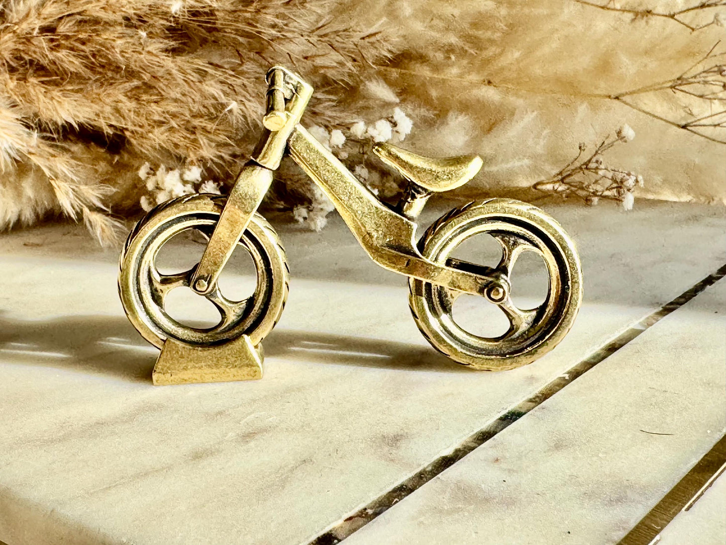 Solid brass balance bike figurine, rolling wheels model, miniature bicycle sculpture, unique metal cycling decor, collectible biker