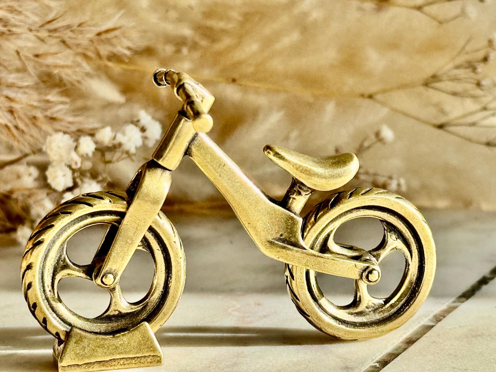 Solid brass balance bike figurine, rolling wheels model, miniature bicycle sculpture, unique metal cycling decor, collectible biker