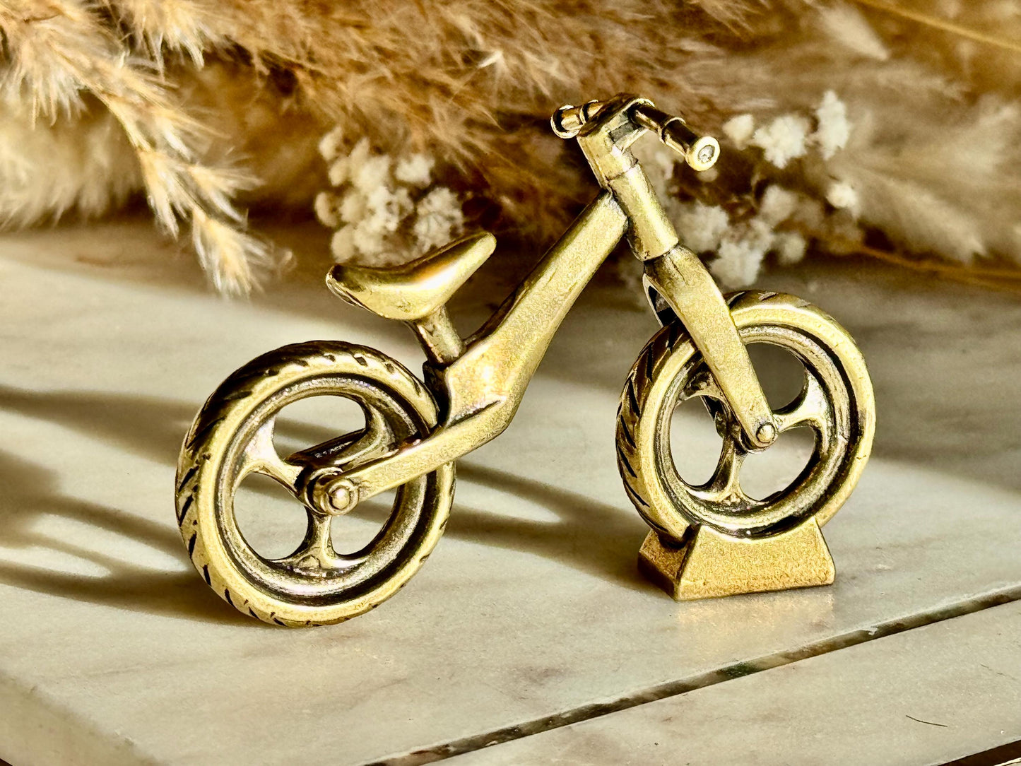 Solid brass balance bike figurine, rolling wheels model, miniature bicycle sculpture, unique metal cycling decor, collectible biker