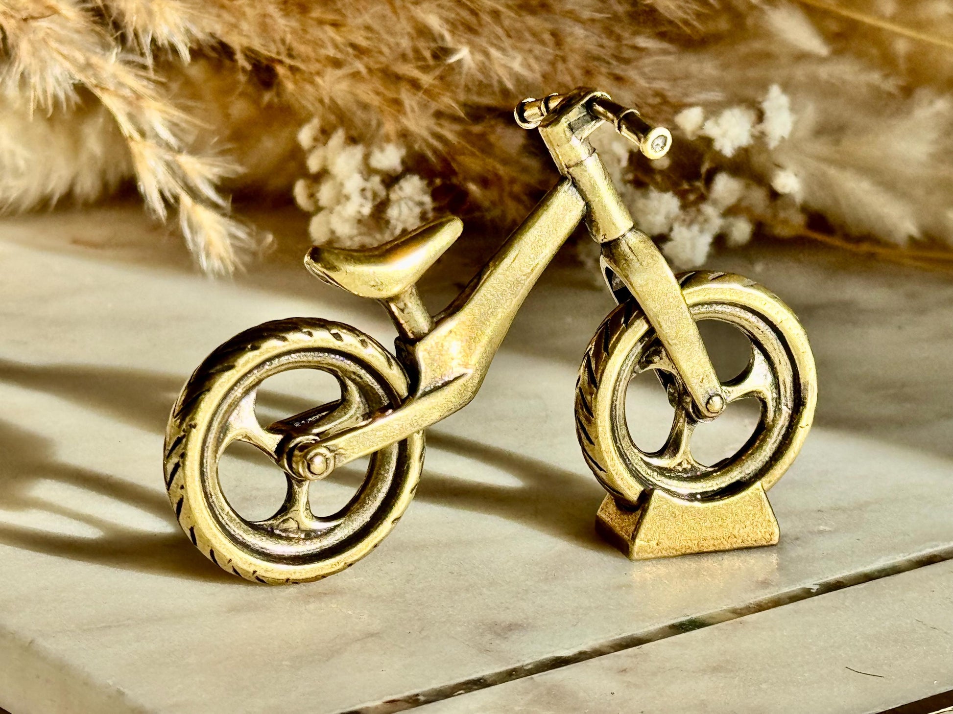 Solid brass balance bike figurine, rolling wheels model, miniature bicycle sculpture, unique metal cycling decor, collectible biker