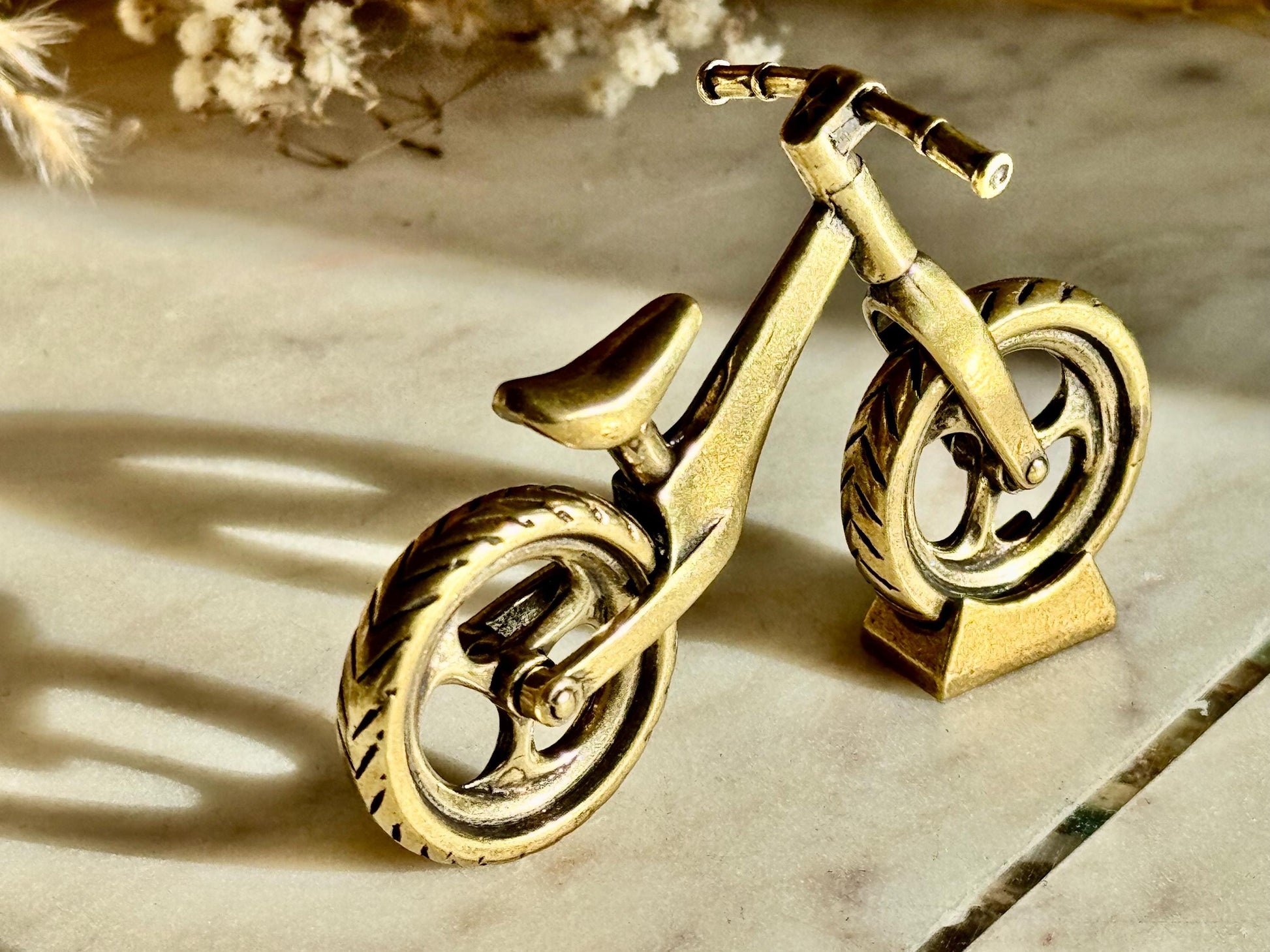 Solid brass balance bike figurine, rolling wheels model, miniature bicycle sculpture, unique metal cycling decor, collectible biker