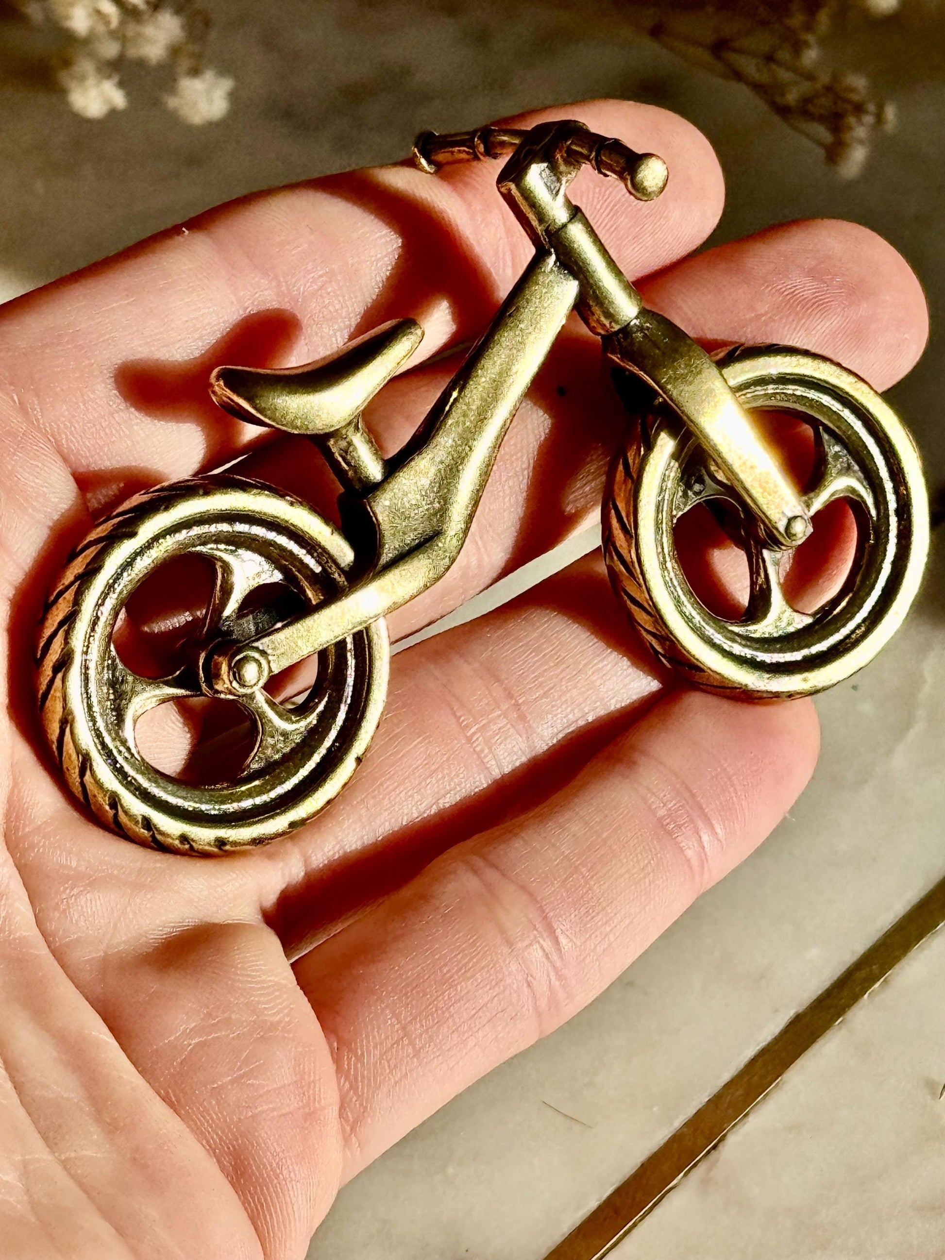 Solid brass balance bike figurine, rolling wheels model, miniature bicycle sculpture, unique metal cycling decor, collectible biker