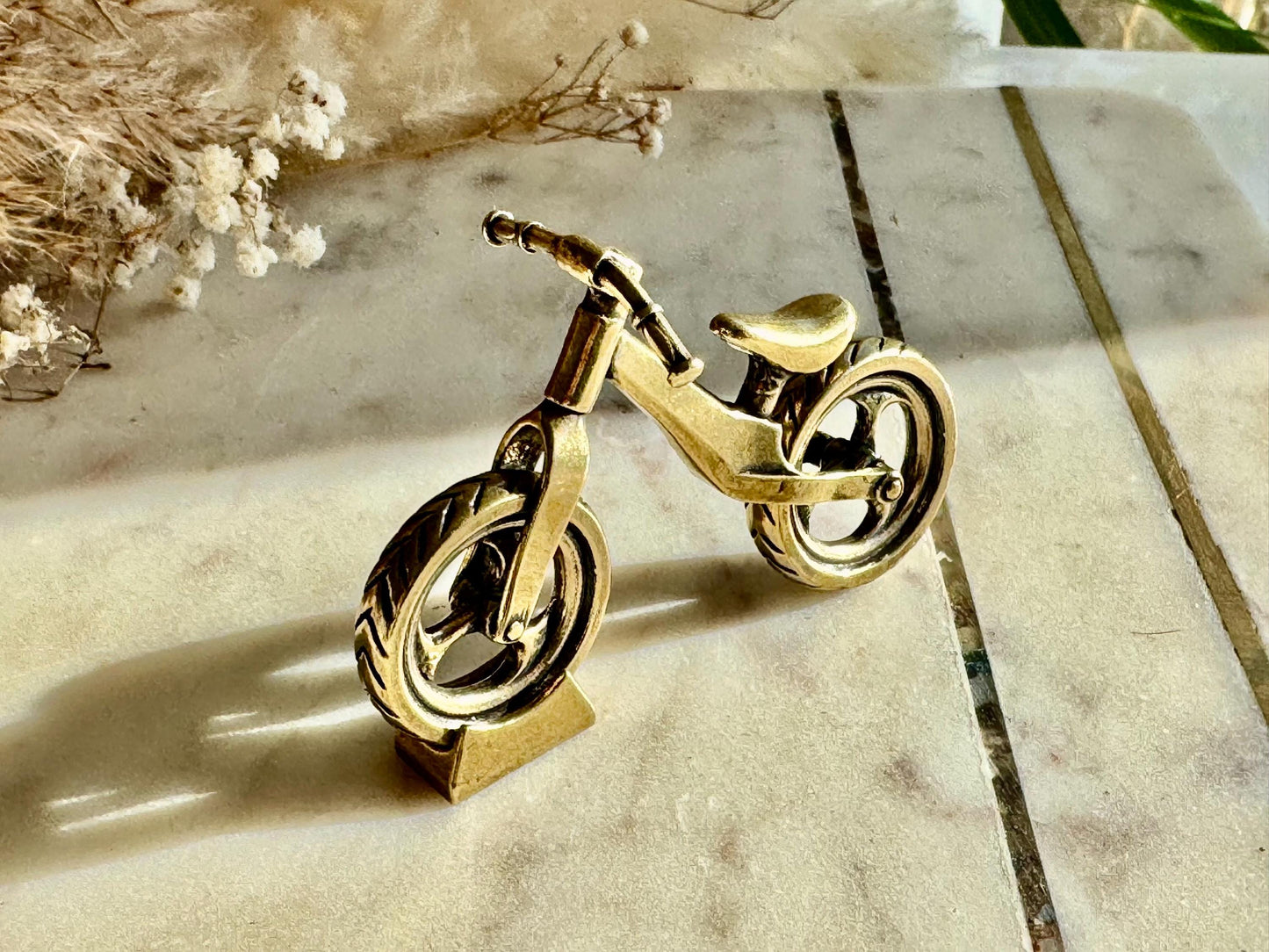 Solid brass balance bike figurine, rolling wheels model, miniature bicycle sculpture, unique metal cycling decor, collectible biker