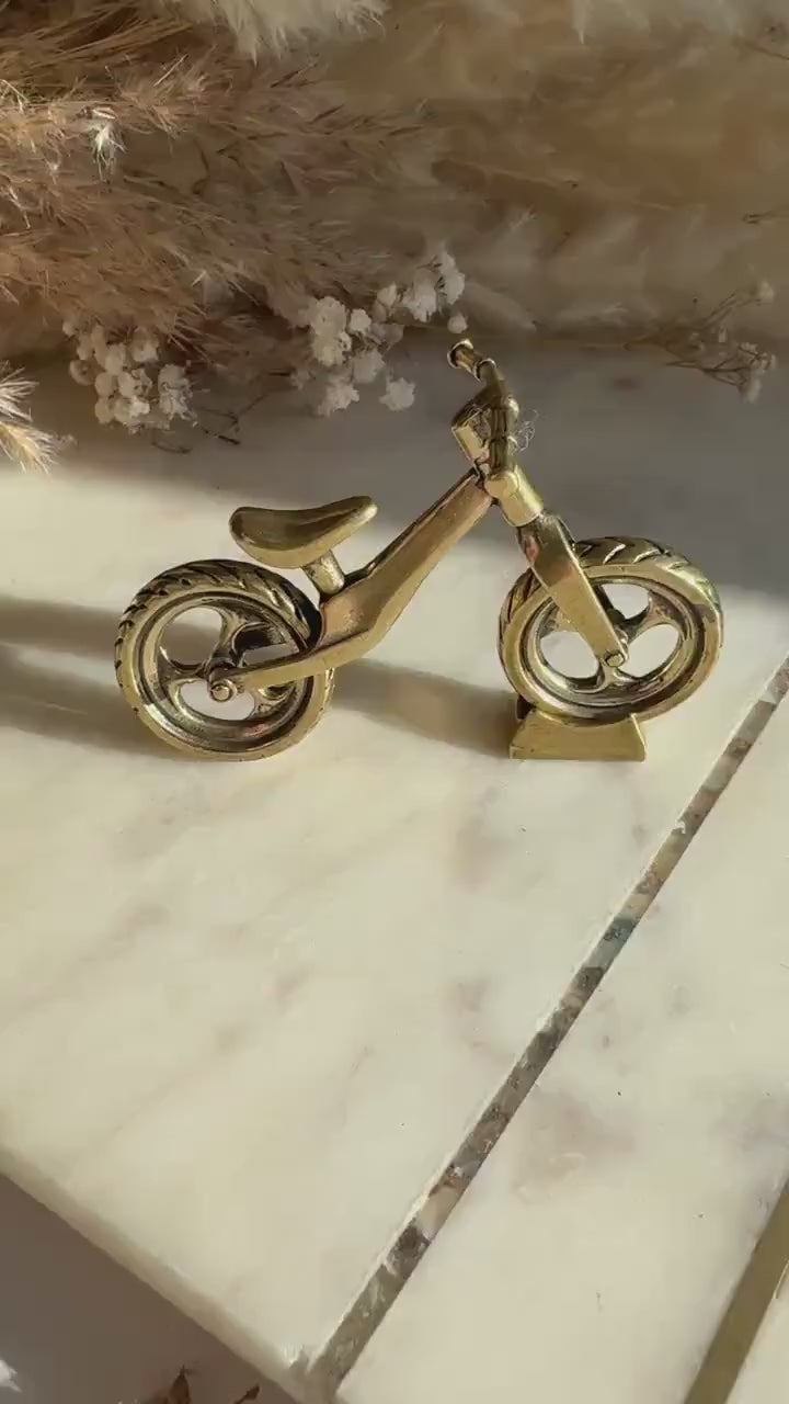 Solid brass balance bike figurine, rolling wheels model, miniature bicycle sculpture, unique metal cycling decor, collectible biker