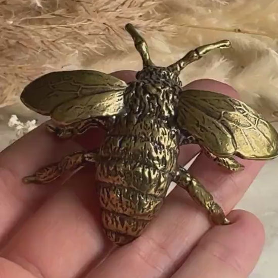 Solid brass bumblebee figurine, realistic bee sculpture, insect ornament, detailed brass garden pollinator paperweight.
